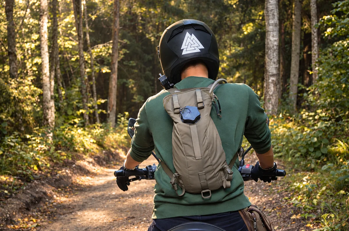 Motorcyclist wearing the SturmPak pack on a forest road
