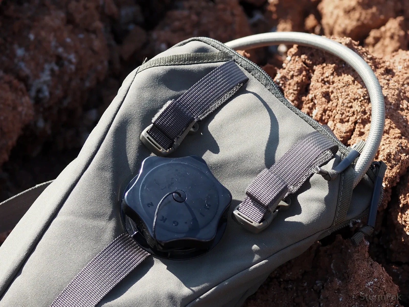 Adjustable hydration pack buckle